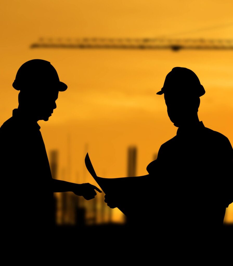 Two construction workers reading document 