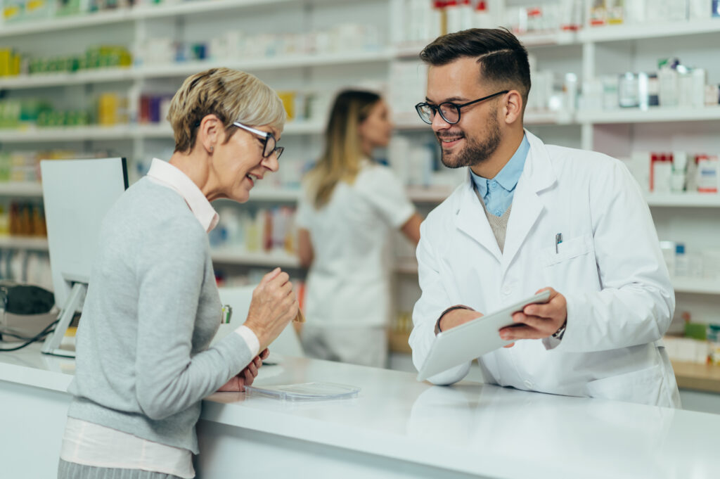 Woman discusses prescription with pharmacist