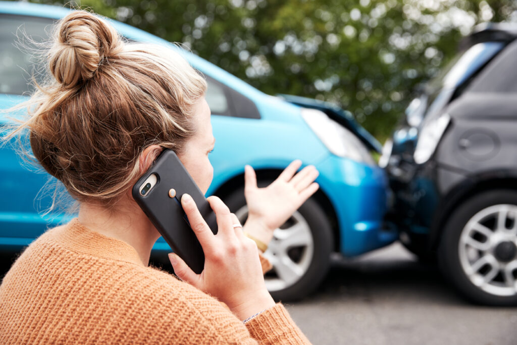 Woman calls her insurance company after a car accident
