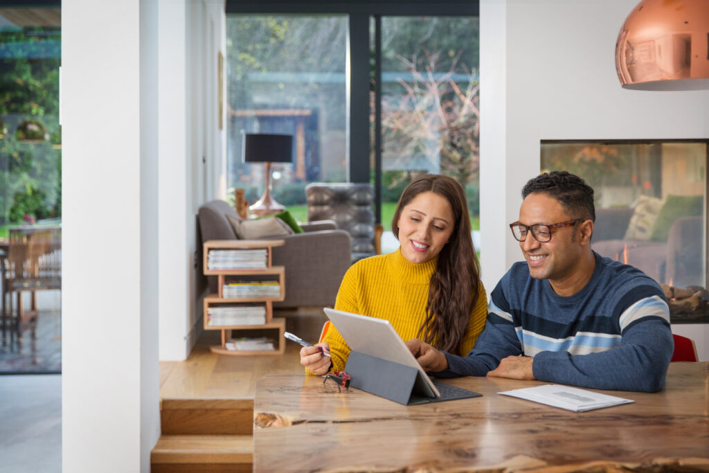 Couple looks over finances with pre-settlement funding happily