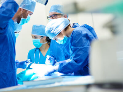 Surgeons work on accident victim who received pre-settlement surgical funding